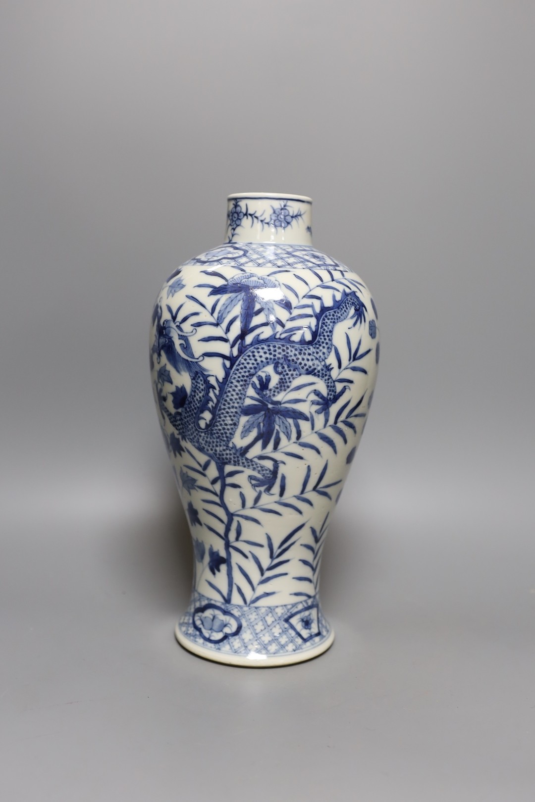 A Chinese blue and white ‘dragon’ vase. Kangxi mark but later, 31cm